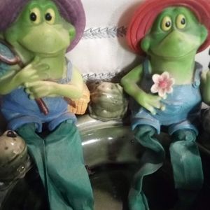 Two frogs sitting around the pond